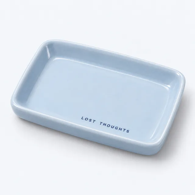 Empty pale blue ceramic catchall tray with Lost Thoughts printed inside
